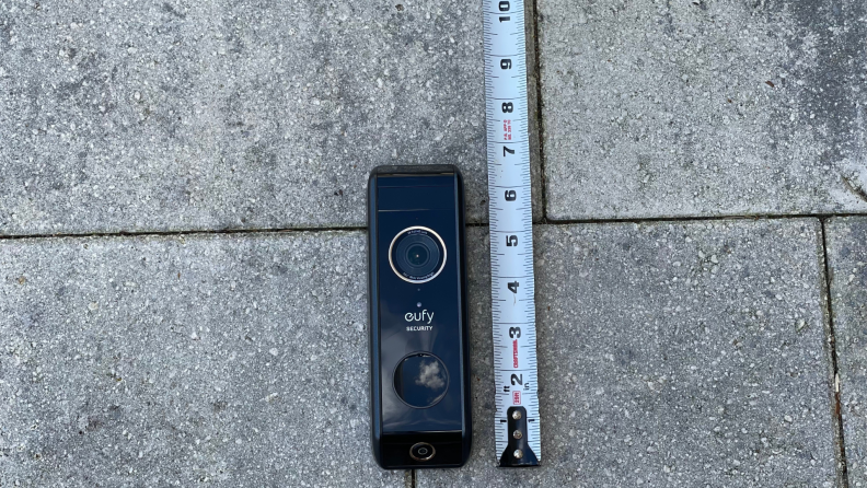 A video doorbell appears next to a tape measure.