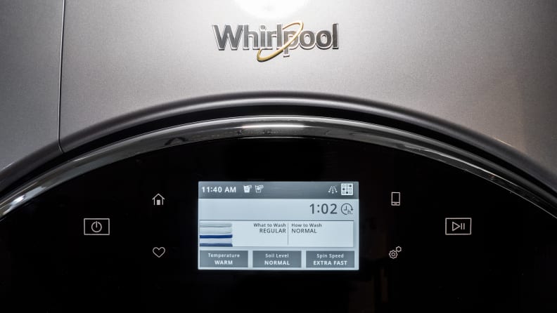 The front of the Whirpool WFW9620HC front-load washing machine; we can see the top part of its door with built-in touchscreen as well as the Whirlpool logo.