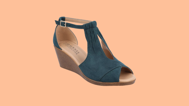 A wedge sandal that has a teal suede upper.