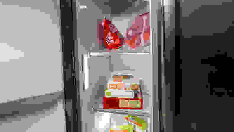 A close-up of the Frigidaire Gallery GRSC2352AF side-by-side refrigerator's freezer compartment, with some food