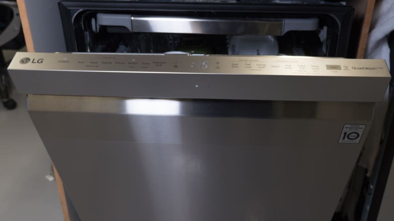 The dishwasher's door remains slightly ajar, revealing its top-facing controls.