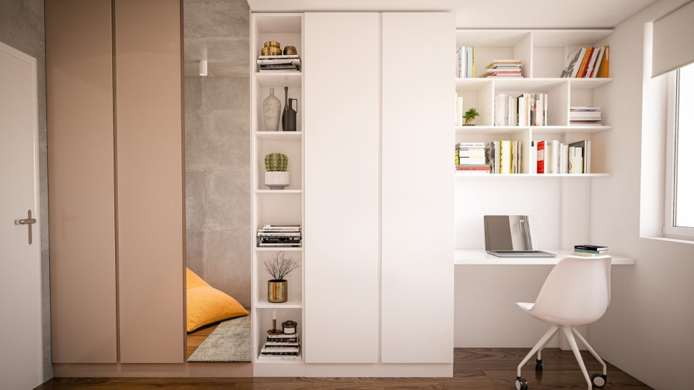 A small desk is tucked into a closet