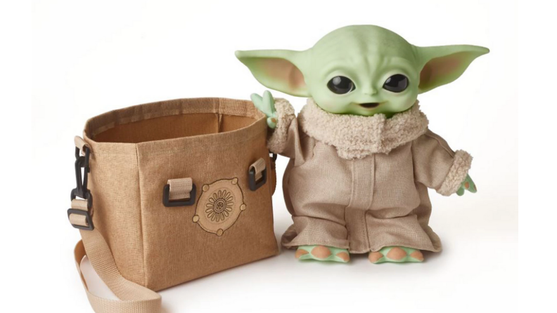 An image of the Child toy (Baby Yoda) next to a carrying satchel.