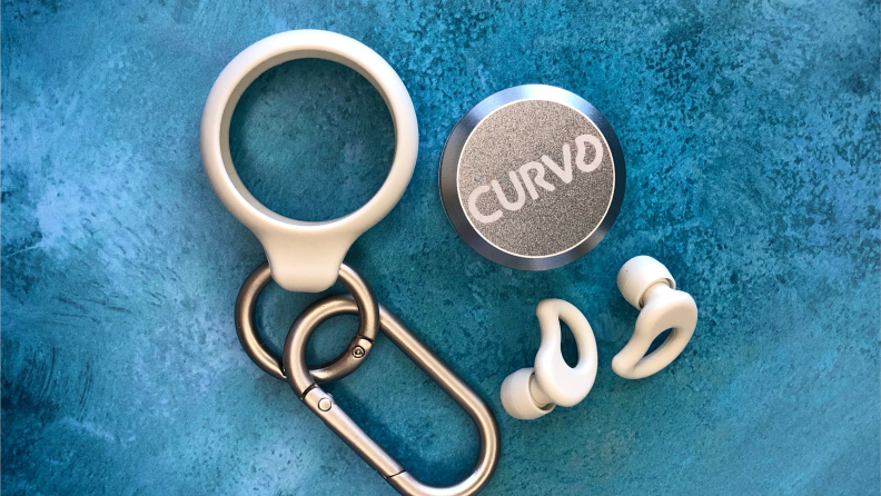 White CURVD ear plugs with a silver carrying case and clip.