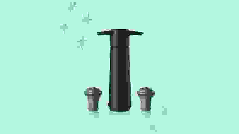 A VacuVin vacuum pump and two rubber corks against a green background with hand-drawn stars