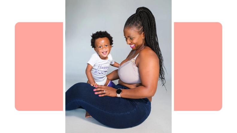 Person smiling while sitting on the ground holding small infant.