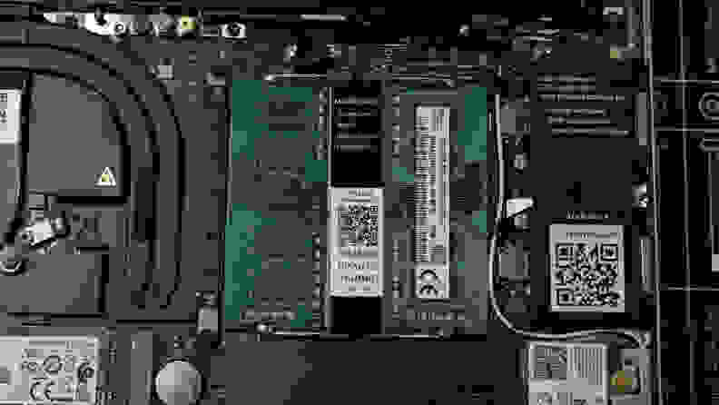 An overhead of a laptop motherboard with DDR4 RAM sticks installed and flaring upward.