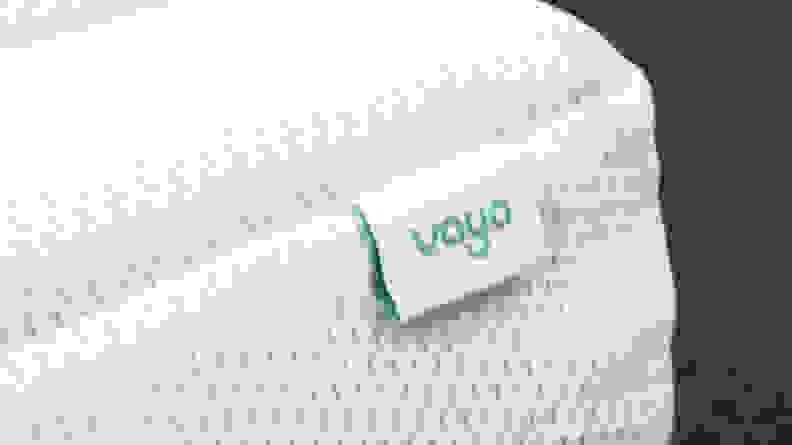 Close-up shot of the Vaya logo printed on a tag located on the corner of the mattress.