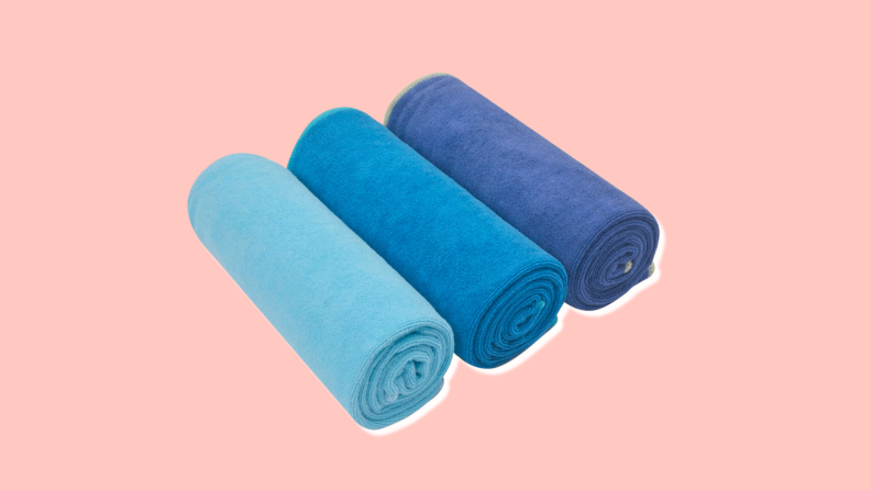 3 Sinland Microfiber Gym Towels of varying shades of blue.