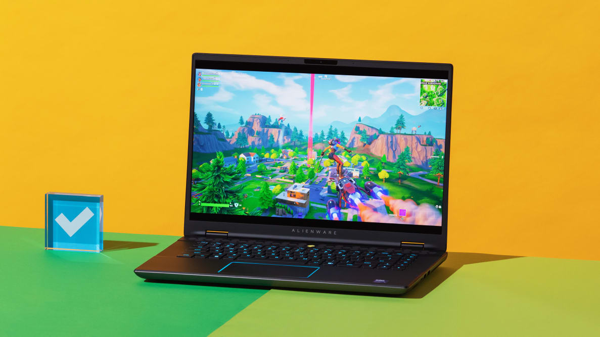 The Alienware m16 R2 gaming laptop with a video game scene on screen on top of a two-tone green surface.