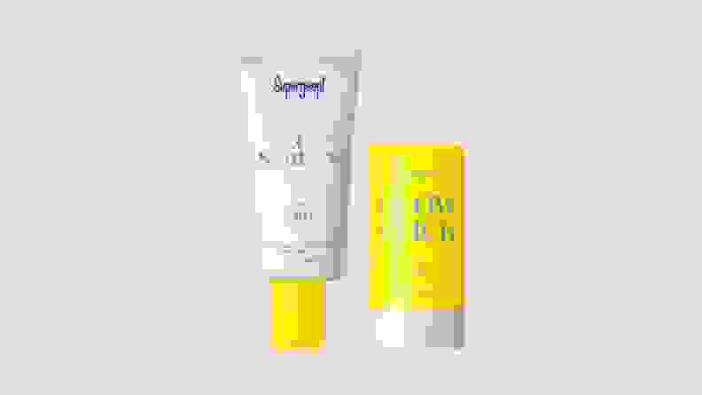 Two sunscreen products stand against a beige background.