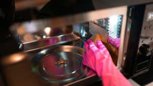 一只粉红色的手套正在清洗微波炉的内部