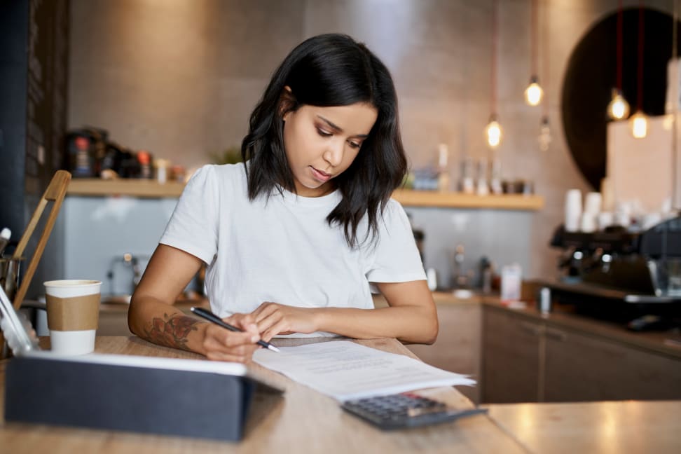 Woman looking over tax document