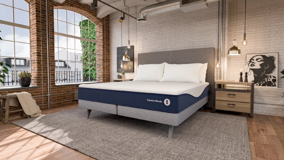 Sleep Number mattress in a modern bedroom with exposed brick, wide windows, and hanging light fixtures