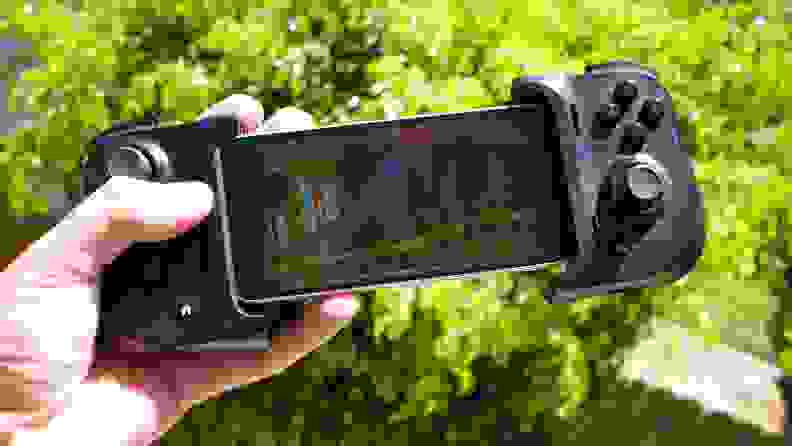 An iPhone 12 Mini docked into a Razer Kishi controller, playing Sonic Mania through Amazon Luna