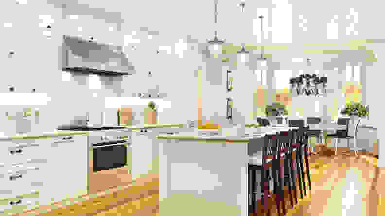 A kitchen with layered lighting from multiple sources