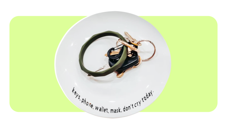 Product shot of a porcelain key dish with key ring inside from NewLifeDesign Co.