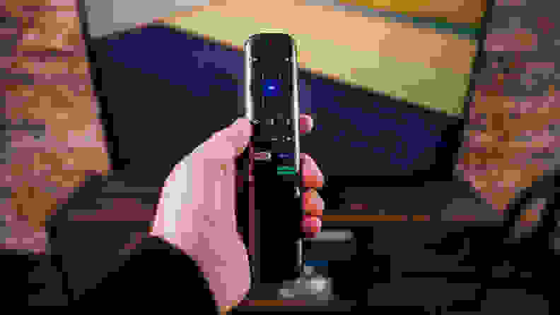 The TCL 6-Series' Roku Remote control being held in front of the screen