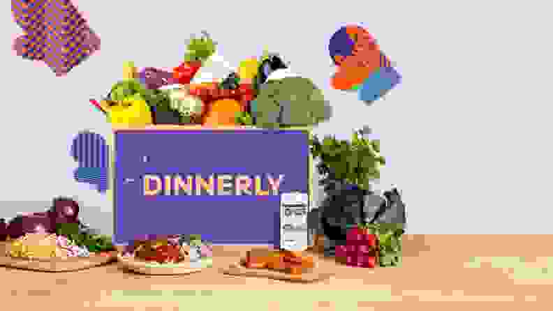 A Dinnerly box with fruits and vegetables popping out of the box.