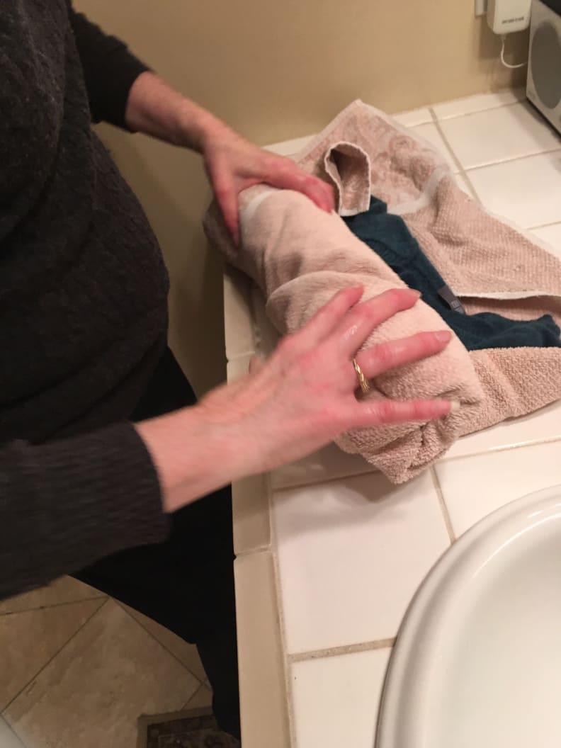 Roll the sweater in a clean, dry towel