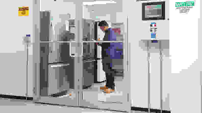 A man stands in front of a fridge inside our testing lab.
