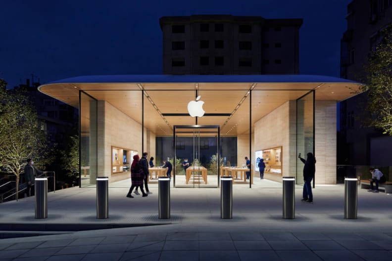 An Apple store open and lit in the dark.