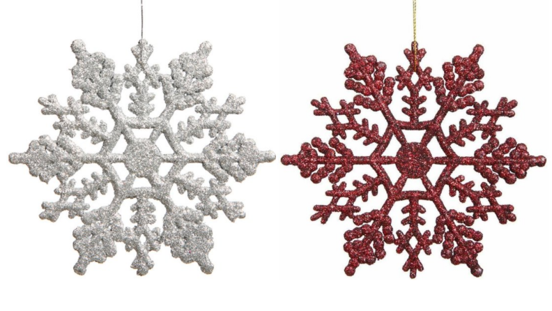 Two glittery snowflake ornaments, one white, one red, hanging together over a white background.