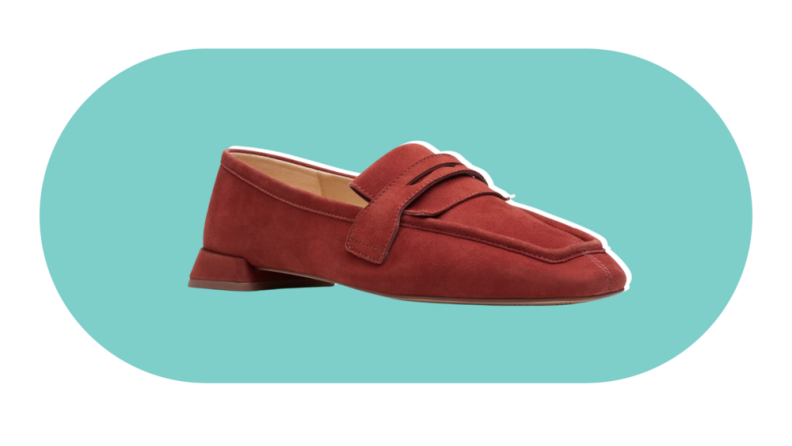 A flat loafer with a slightly pointed square toe in a chestnut brown suede material.