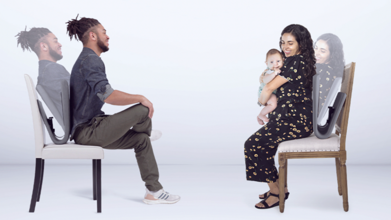 Two adults sit on dining room chairs with Ready Rockers.