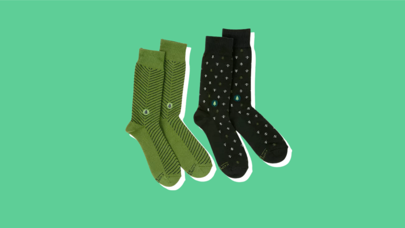 Two sets of The Giving Socks on a green background.