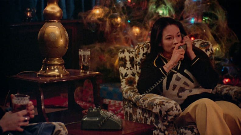 Olivia Hussey sitting in a chair, surrounded by Christmas decorations, in a scene from "Black Christmas."