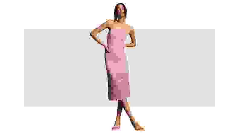A model wearing a lilac-colored midi dress made from lace fabric.