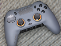 Gray Scuf Envision Pro gaming controller on top of gray cloth surface.