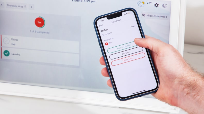 Person holding phone with Skylight app