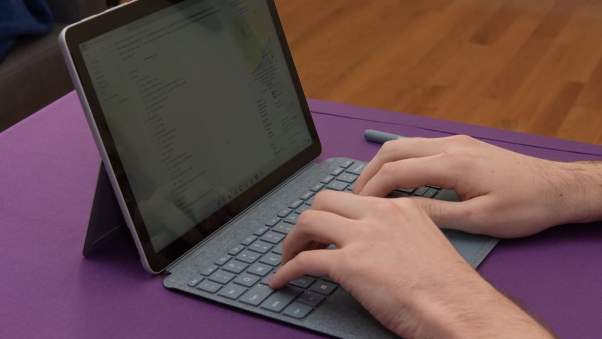 Person typing on the laptop keyboard