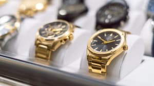Gold watches in a display case.