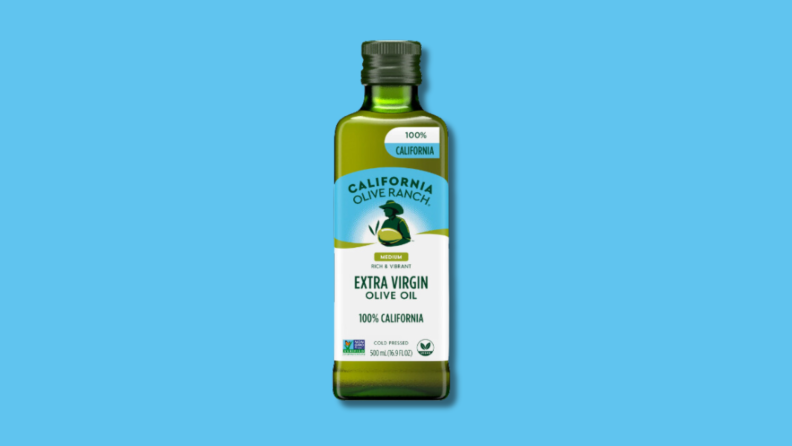 Greeen, rectangular bottle of  Olive Ranch 100% California Extra Virgin Olive Oil in front of blue background.