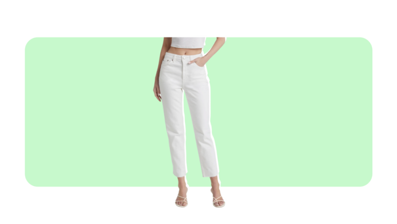 A model wears cropped white skinny jeans.