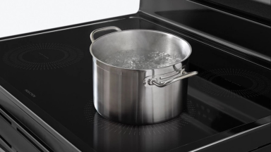 A pot of water boils quickly on a convection range