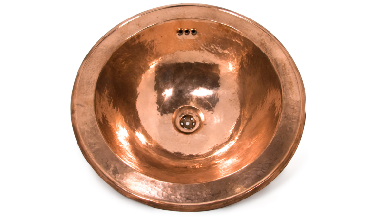 Copper round sink against a white background.