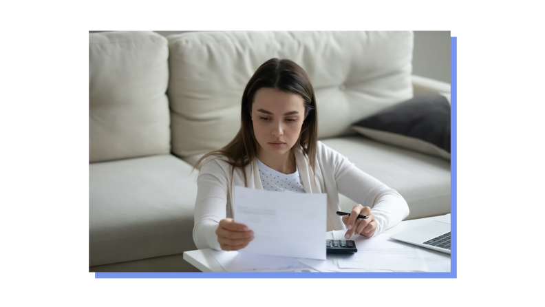 Person sitting on floor while sitting while reviewing bills and budgeting.