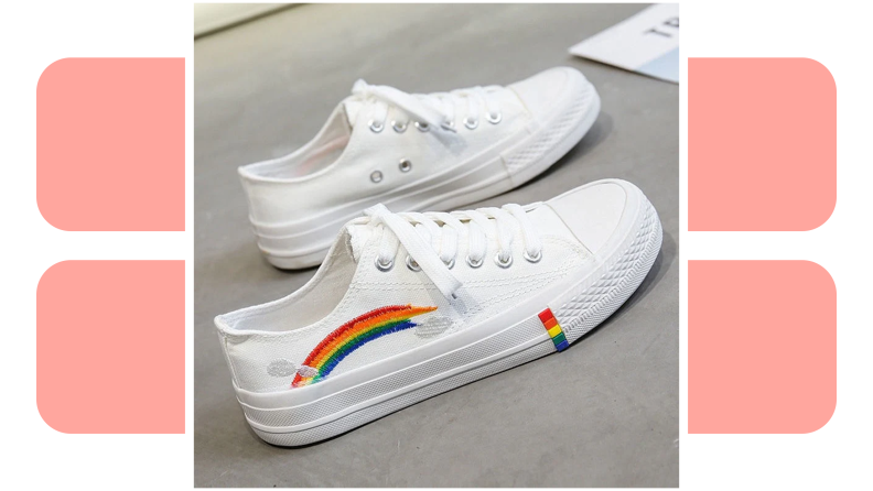 A pair of white sneakers embroidered with rainbows.
