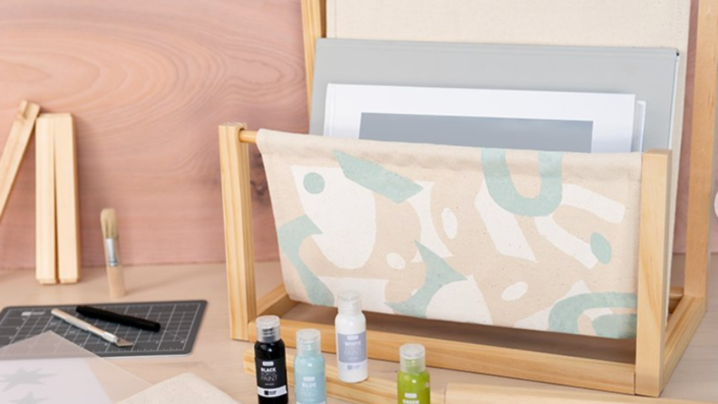 A screen-printed KiwiCo book holder in pastel colors