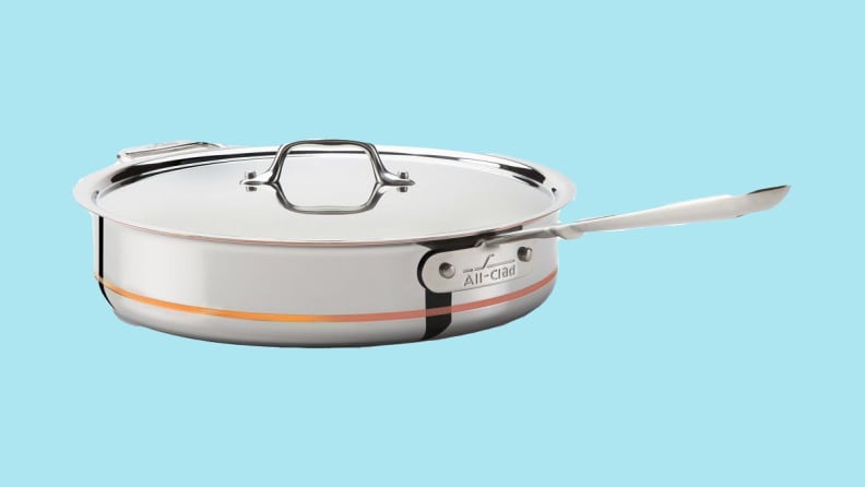 An All-Clad sautee pan against a blue background.