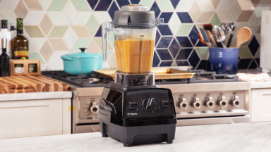 Vitamix blender filled with butternut squash soup on a kitchen countertop