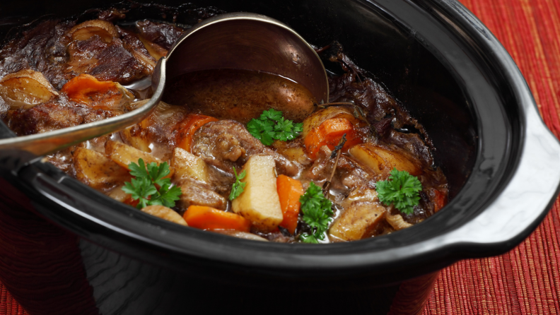 A black pot of Irish stew containing mutton, carrots, potatoes, and spices.