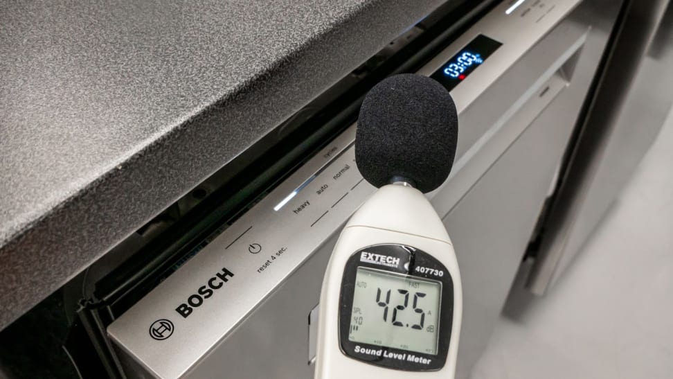 A sound meter measuring the noise level of a Bosch 800 series dishwasher.