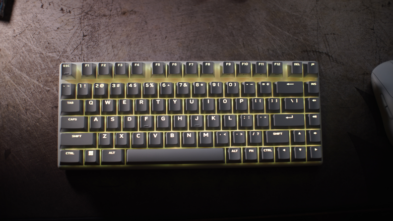 The Alienware Pro Wireless Gaming Keyboard with yellow LED lights glowing inside the keyboard.