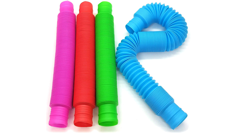 Pink, red, green, and blue plastic tube toys on a white background