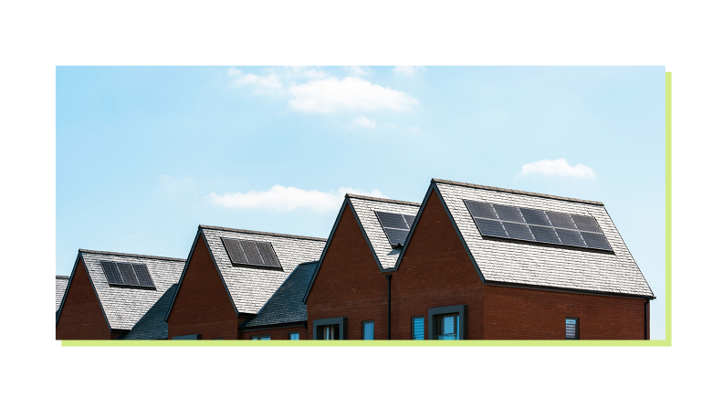 Clear, blue sky over a row of suburban homes with solar panels on top shingled roofs.
